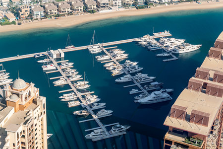 fast boats and luxury yachts are parked in the port at the pier near the beach. view from above.の写真素材