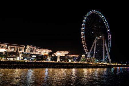 November 29th, 2022 Dubai UAE. Colorful view of the illuminated Address beach resort and the dubai eye ferris wheel. palm jumeirah west at Dubai, UAE.のeditorial素材