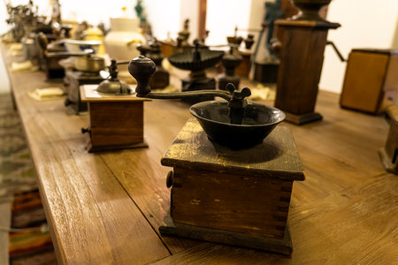 a lot of old antique various coffee grinders from different countries of the world on the table in the coffee museum. Dubai. United Arab Emirates. U.A.E. November 27, 2022のeditorial素材