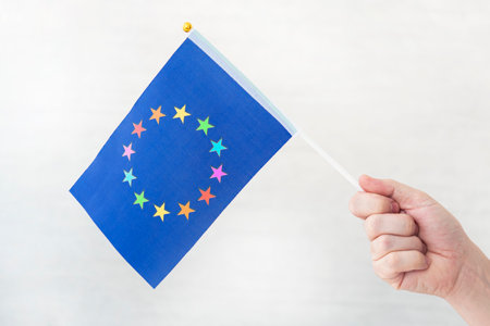 EU flag and flag of the LGBT community. problem of rights of sexual minorities in the country. protection and infringement rights. non-traditional relations and politics concept. legalizing same-sex marriageの写真素材
