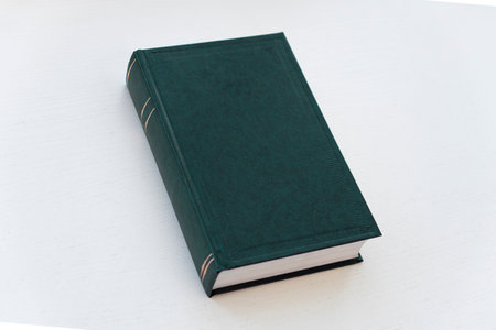 green hardcover book on white background with copy space
