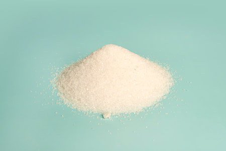 white granulated sugar on a blue background.