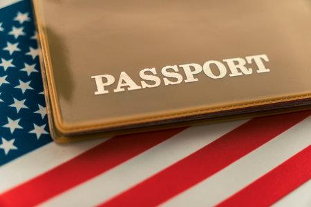 United States of America citizen Passport with biometric ID chip on USA national flag. personal identification document. Close up, copy space, background, top view, flat lay.の写真素材