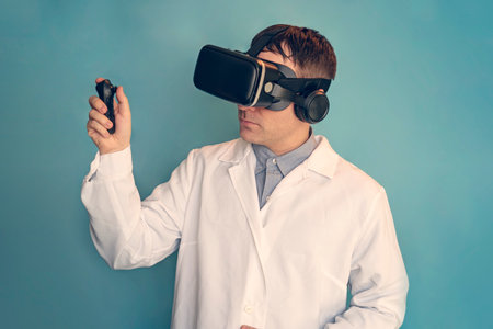 Medical doctor using virtual reality headset at his work. a doctor in a VR helmet on a blue background. telemedicine conceptの写真素材