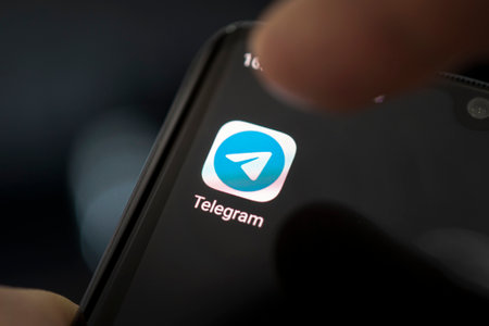 Barnaul. Russia. February 9, 2021: Telegram icon app on the screen smartphone closeup. Telegram is an online social media network.のeditorial素材
