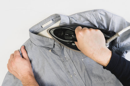 modern man lifestyle, ironing clothes and homework. close up. top viewの写真素材