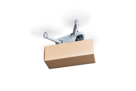 Postal Drone Isolated on White Background. Drone carrying carton package. Drone Technologyの写真素材