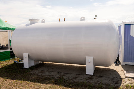 large white liquid storage tank outside. a barrel for fuel or waterの写真素材
