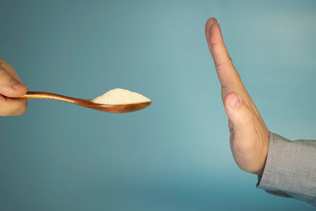 the concept of refusing sweets. The stop hand gesture is a prohibition symbol. Rejection of sugar.の写真素材