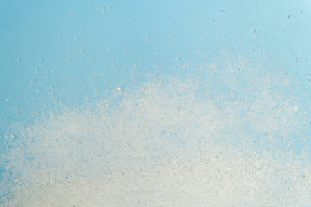 White sea salt in bowl isolated on blue top viewの写真素材
