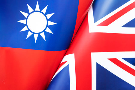 Background of the flags of the taiwan and Great Britain. The concept of interaction or counteraction between the two countries. international relations. political negotiations. sports competition.の写真素材