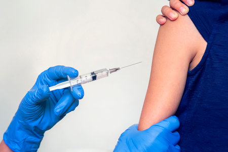 doctor makes the patient an injection on white background close up