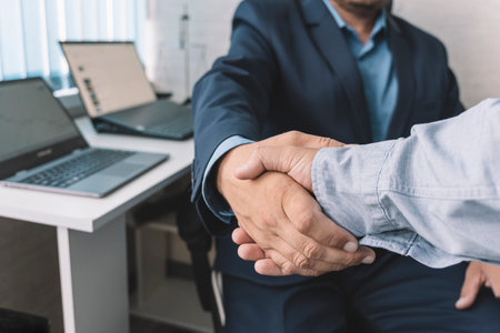 young manager handshake with new employee. close-up handshake. The concept of a perfect transaction in business.の写真素材