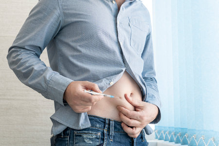 Male Diabetic Injecting Themselves With Insulin. self-treatment of type 1 diabetesの写真素材