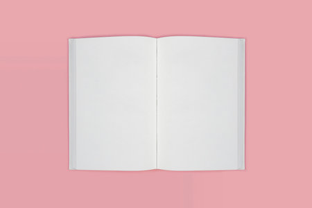 Open book of blank pages top view on a pink background. copy spaceの写真素材