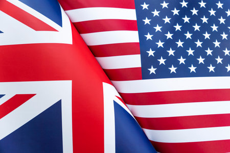 Background of the flags of the USA and Great Britain. The concept of interaction or counteraction between the two countries. International relations. political negotiations. Sports competition.の写真素材