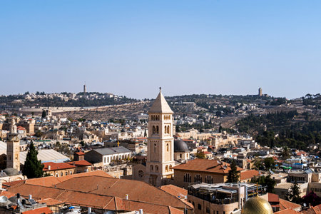 Panoramic view on old part of Jerusalem city, Israel. Ancient jewish city shot from above on a sunny cloudless day. Tiled roofs, chapels and dome of churches of Jerusalem at blue sky backgroundの写真素材
