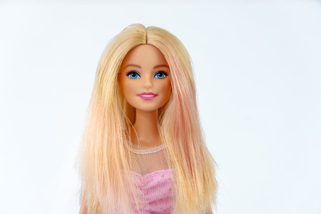 October 9, 2023. Barnaul, Russia: Portrait of a Barbie doll with loose blond hair in a pink dress on a white background. Portrait of a Barbie.のeditorial素材