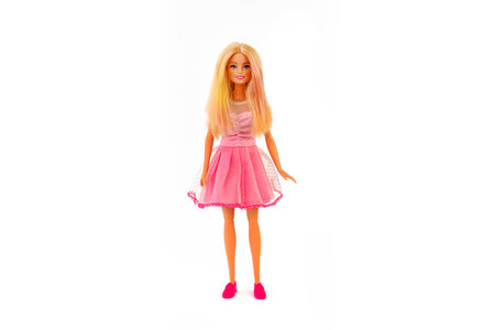 October 9, 2023. Barnaul, Russia: Barbie doll with loose blond hair in a pink dress standing isolated on a white background.のeditorial素材