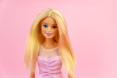 October 9, 2023. Barnaul, Russia: Portrait of a Barbie doll with loose blond hair on a pink background.のeditorial素材