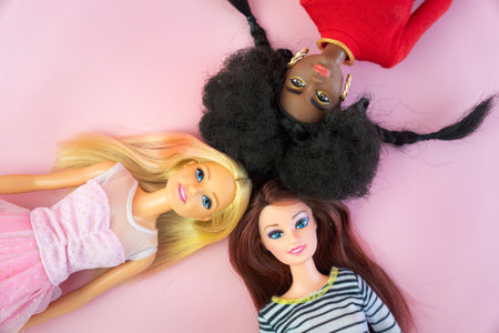 October 9, 2023. Barnaul, Russia: Portrait on top view of Barbie dolls lying on pink backgroundのeditorial素材