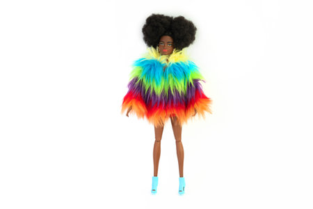 October 9, 2023. Barnaul, Russia: african american Barbie doll with black hair in a red suit standing isolated on a white background.のeditorial素材