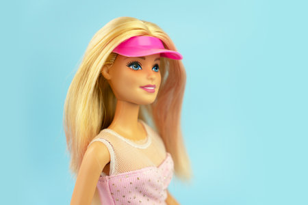 October 9, 2023. Barnaul, Russia: Portrait of a Barbie doll with loose blond hair on a blue background.のeditorial素材