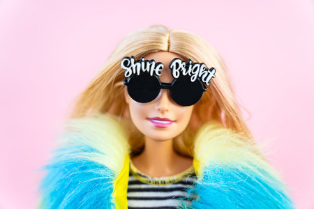 October 9, 2023. Barnaul, Russia: Portrait of a Barbie doll with loose blond hair on a pink background.のeditorial素材