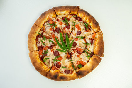 Homemade pizza with marijuana cannabis leaves. Fresh medical marijuana, cannabis decorate on pizza. close-up, macro,の写真素材