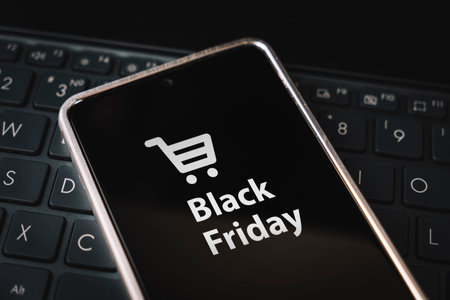 black friday sale. special offer discount text on mobile phone screen message. Get promotional code for discounted purchases during the sale. Buying through the Internet. The concept of e-commerce.の写真素材