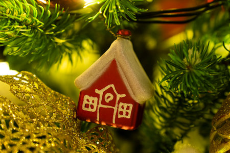 Christmas tree decoration in the form of a house on a branch. housing rental concept, realtor services, mortgage, purchase, loanの写真素材