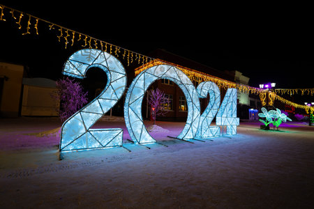 2023 figures on snow on a dark night background. Decorative figures decorate the city square for the...