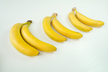 Fresh bananas on white wooden background. top viewの写真素材