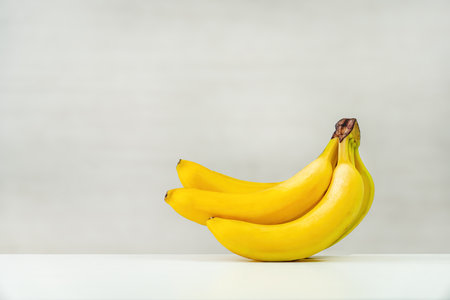 Sweet bananas on white wooden table on a white background. copy spaceの写真素材