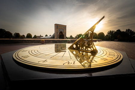An old sundial showing the time. beautiful gilded sundial on a background of sunlight at sunset.