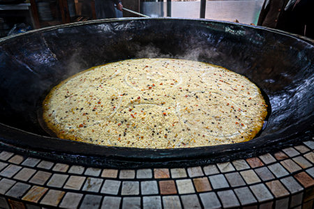 Cooking of plov in the Kazan cauldron at Central Asian Plov Centre, Tashkent, Uzbekistanの写真素材