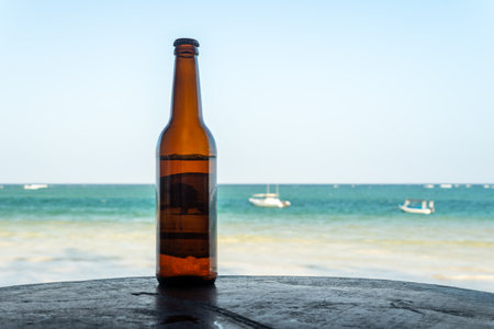 Bottle of beer on the beach, copy spaceの写真素材