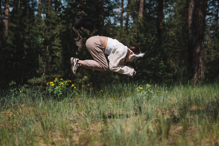 Teenage girl with cat mask and gloves doing Quadrobics. A girl in a cat mask Jumps like a catの写真素材