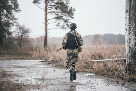 Soldier or militiaman in camouflage with assault rifle fighting in ruins. A special forces soldier...