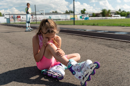 a schoolgirl girl without protective equipment fell on the asphalt while roller skating at the...