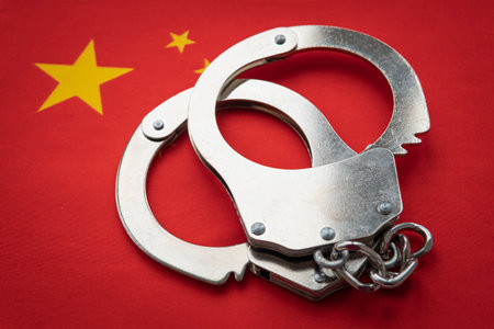 China flag and police handcuffs. The concept of observation of the law in country and protection from crimeの写真素材