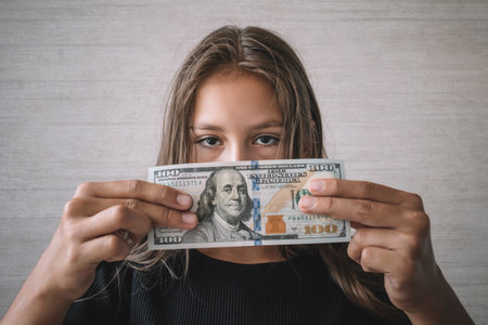 Child and US Dollars. Concept - the development of materialism from childhood.の写真素材