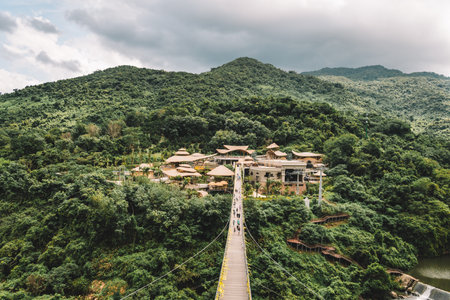 A long suspended wooden bridge in the forest park YaNoDa, A national park in the center of Hainan Island, China.の写真素材