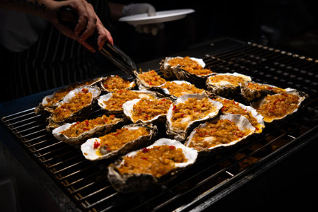 Grill oyster in the street market. Street food at a night market in Sanya, Hainan Island in China.の写真素材
