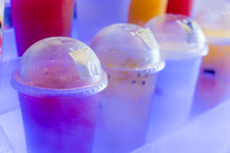 Soft drinks in plastic cups in the refrigerator