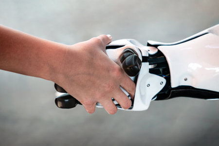 Cyber communication design concept. robot and Female human holding hands with handshake.の写真素材