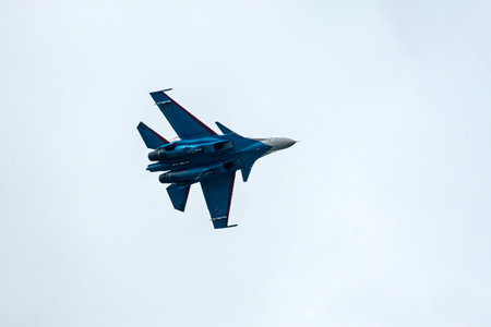 Aerobatics from Russian Knights and Swifts. Russian military aircraft show aerobatics in the blue sky against the background of clouds.の写真素材