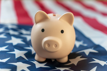 piggy bank is positioned proudly American flag, symbolizing savings and financial aspirations. the concept of saving money.の写真素材