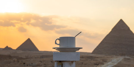 White mug with tea or coffee on a beautiful background of the main attractions of Egypt, the Great...