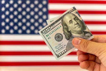100 dollar bill with American flag. Debt ceiling, stock market and financial concept.の写真素材